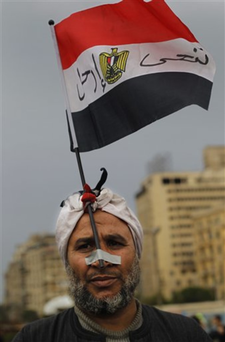 An Egyptian anti-government demonstrator stands in Tahrir Square, the center of anti-government demonstrations, in Cairo, Egypt, Sunday, Feb. 6, 2011. A sense of normalcy began to return to the capital of some 18 million people, which has been largely closed since chaos erupted shortly after the protests began on Jan. 25. (AP Photo/Lefteris Pitarakis)
